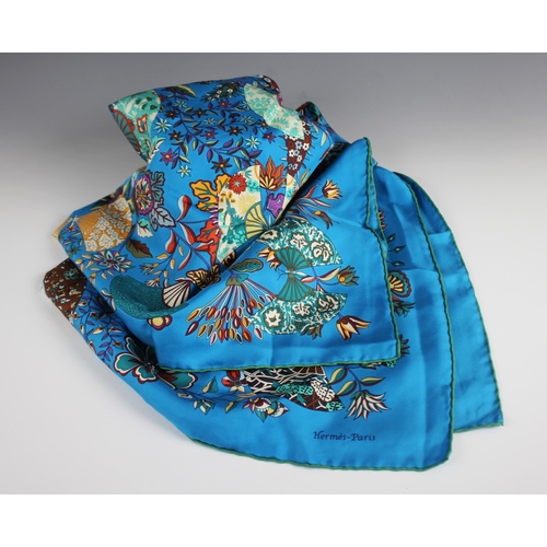 594 - A 'Hermes' style scarf, designed with fans and spraying foliage, against a turquoise ground, with ro... 