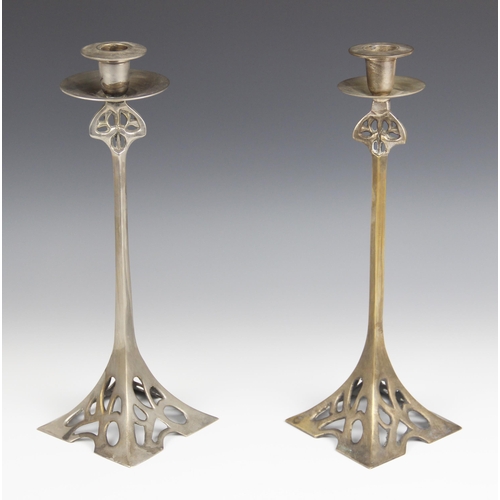 638 - A pair of Art Nouveau/Jugendstil style candlesticks in the manner of WMF, each of tapering form with... 