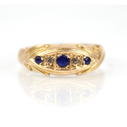 65 - An Edwardian diamond and blue stone 18ct gold ring, the central navette shaped panel set with round ... 