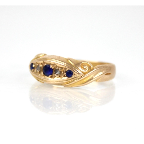 65 - An Edwardian diamond and blue stone 18ct gold ring, the central navette shaped panel set with round ... 