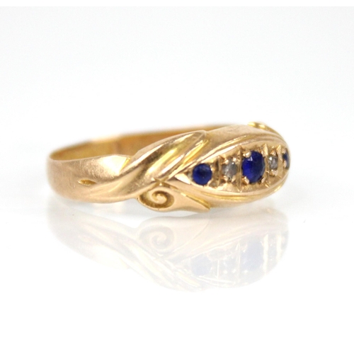 65 - An Edwardian diamond and blue stone 18ct gold ring, the central navette shaped panel set with round ... 