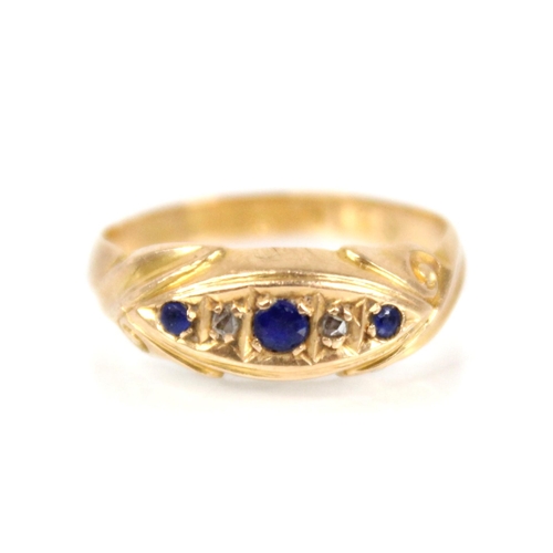 65 - An Edwardian diamond and blue stone 18ct gold ring, the central navette shaped panel set with round ... 