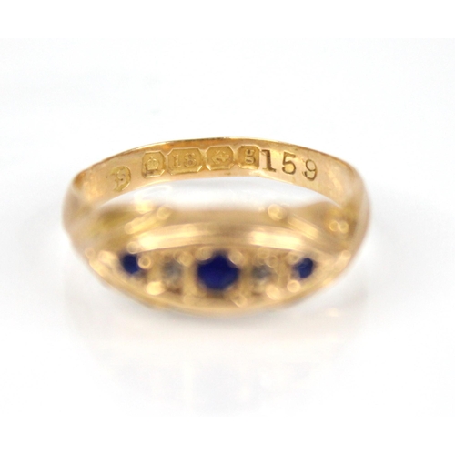 65 - An Edwardian diamond and blue stone 18ct gold ring, the central navette shaped panel set with round ... 