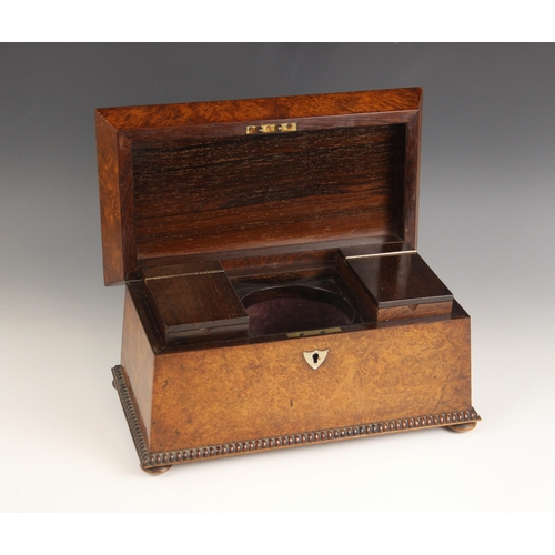 665 - A burr walnut and rosewood sarcophagus shaped tea caddy, early 19th century, the hinged cover inlaid... 