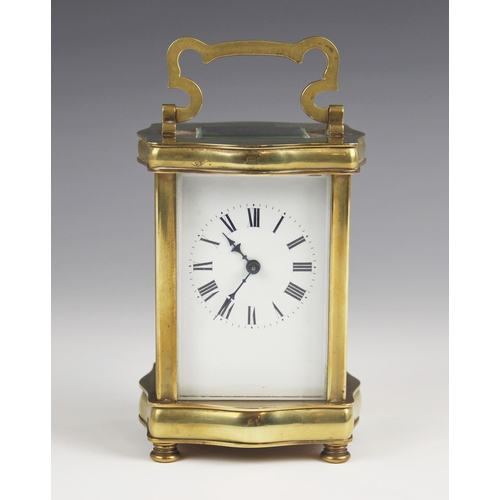 679 - A late 19th century lacquered brass carriage timepiece, the serpentine case with a swing handle abov... 