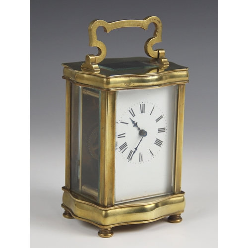 679 - A late 19th century lacquered brass carriage timepiece, the serpentine case with a swing handle abov... 