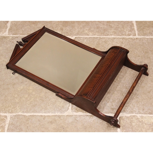 699 - An Edwardian walnut framed toilet mirror, the bevelled rectangular mirror plate below an architectur... 