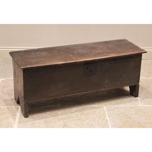 707 - A 17th century and later oak six plank coffer, the hinged plank top with a channelled edge, raised u... 