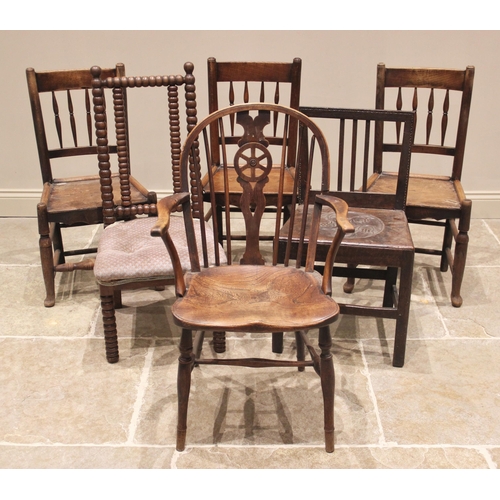 711 - Three 18th century elm spindle back country chairs, each with four tapering spindles above a figured... 