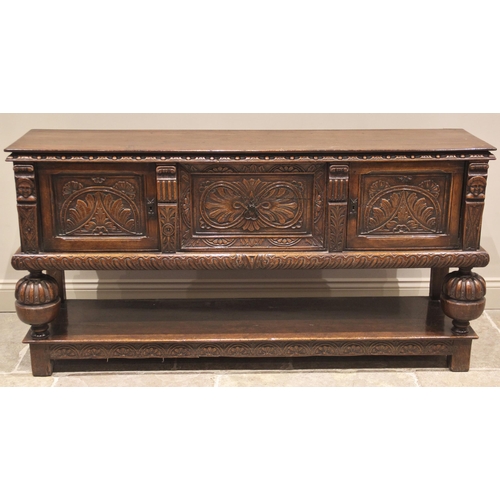 715 - A Jacobean revival oak dresser, early 20th century, formed from three cupboard doors carved with geo... 