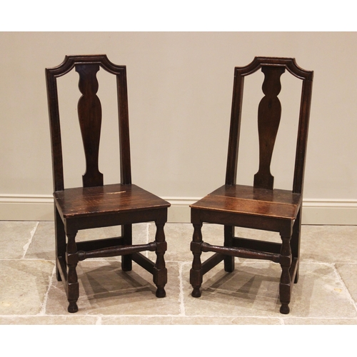 718 - A near pair of oak side chairs, late 17th/early 18th century, each with a vase shaped splat above a ... 