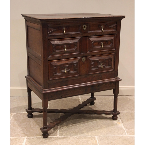 719 - An oak chest on stand, late 17th/early 18th century, the moulded plank top above an arrangement of t... 