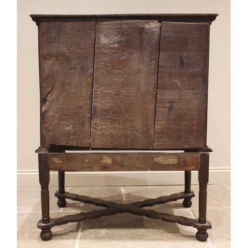 719 - An oak chest on stand, late 17th/early 18th century, the moulded plank top above an arrangement of t... 