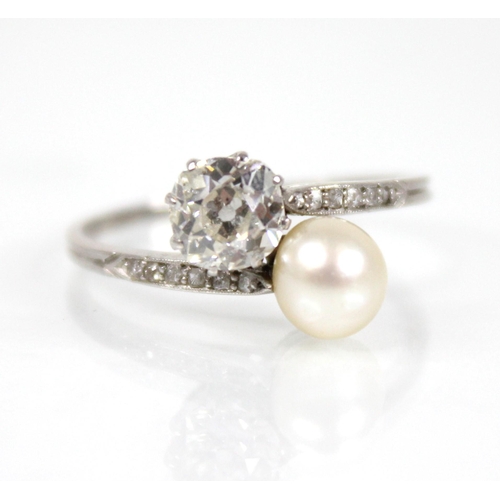 72 - An early 20th century diamond and pearl ‘moi et toi’ ring, comprising an old cut diamond measuring 5... 