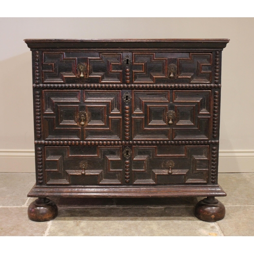 724 - A Jacobean oak chest of drawers, late 17th century, the twin plank top above an arrangement of three... 