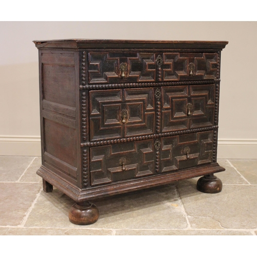 724 - A Jacobean oak chest of drawers, late 17th century, the twin plank top above an arrangement of three... 