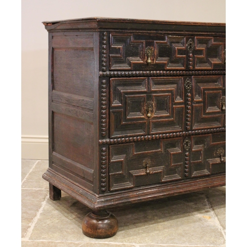 724 - A Jacobean oak chest of drawers, late 17th century, the twin plank top above an arrangement of three... 