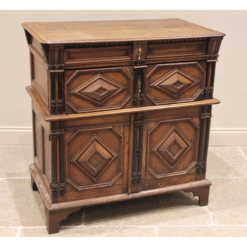 725 - A Jacobean oak two section chest, late 17th century, the moulded and rounded plank top with a dentil... 