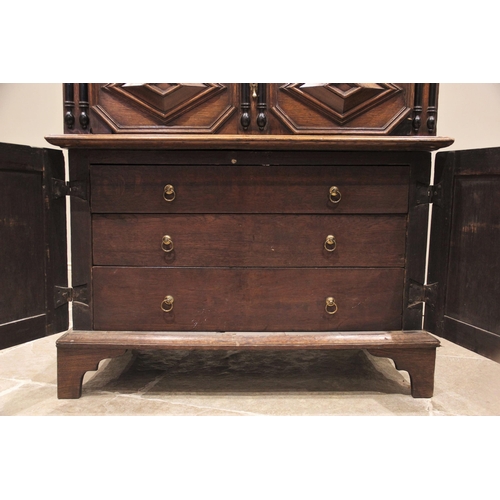 725 - A Jacobean oak two section chest, late 17th century, the moulded and rounded plank top with a dentil... 