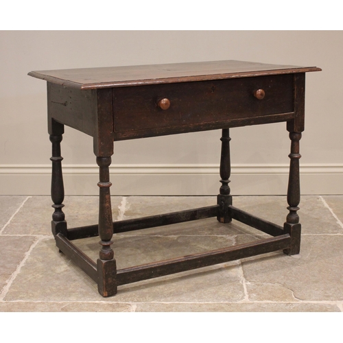 728 - An 18th century oak side table, the rectangular moulded plank top above a single frieze drawer, upon... 