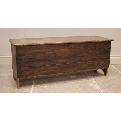 729 - An 18th century stained pine and elm six plank coffer, the hinged cover opening to a fitted candle b... 