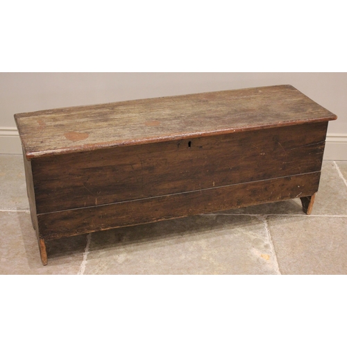 729 - An 18th century stained pine and elm six plank coffer, the hinged cover opening to a fitted candle b... 