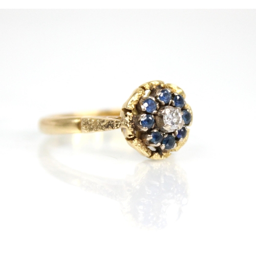 73 - A sapphire and diamond floral cluster ring, the central round brilliant cut diamond weighing approxi... 