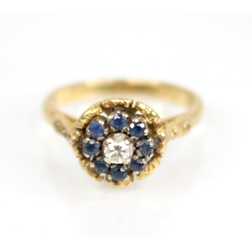 73 - A sapphire and diamond floral cluster ring, the central round brilliant cut diamond weighing approxi... 