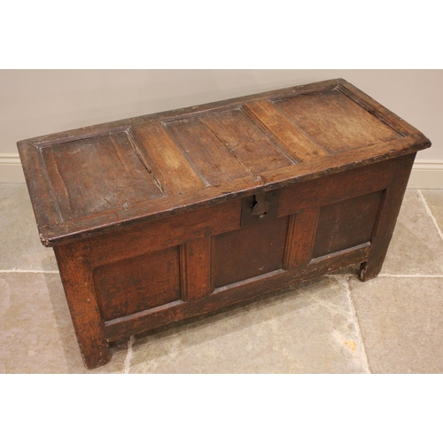 730 - An 18th century oak panelled coffer, the three panel hinged cover applied with an iron clasp lock an... 