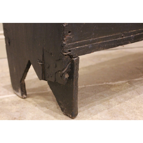 731 - An early 18th century painted oak six plank coffer, the hinged cover with a channelled front edge op... 