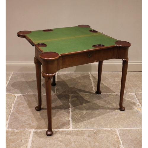 733 - A George II mahogany triple fold over combination games and card table, the rectangular folding top ... 