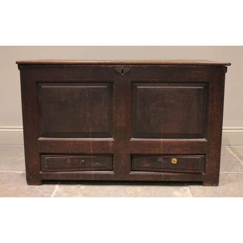 735 - An 18th century oak mule chest, the rectangular hinged top opening to reveal a vacant interior above... 