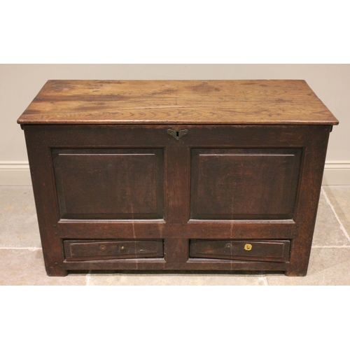 735 - An 18th century oak mule chest, the rectangular hinged top opening to reveal a vacant interior above... 