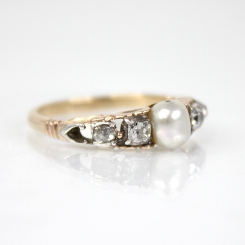 74 - A Victorian and later pearl and diamond ring, the central pearl measuring 5.7mm x 5.5mm, with two ol... 