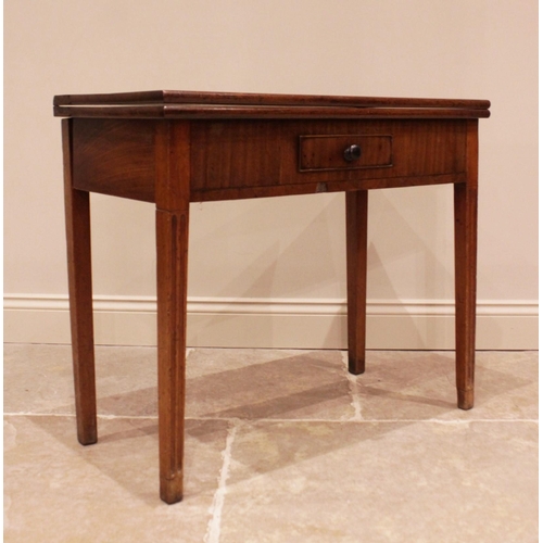 741 - A George III mahogany tea table, the rectangular folding top above a single frieze drawer, raised up... 