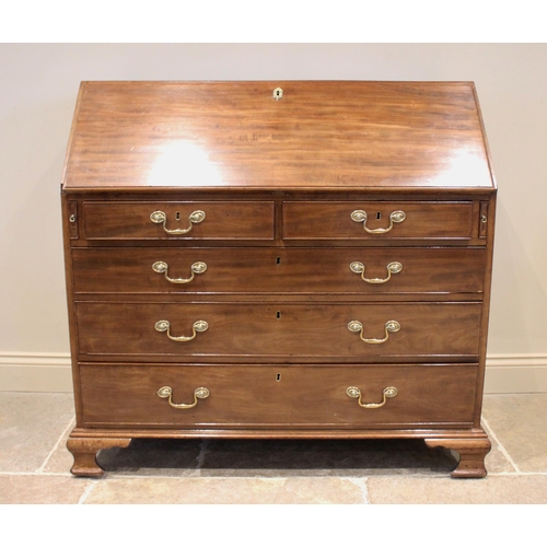 748 - A George III mahogany bureau, the fall front above two short and three long drawers and opening to r... 