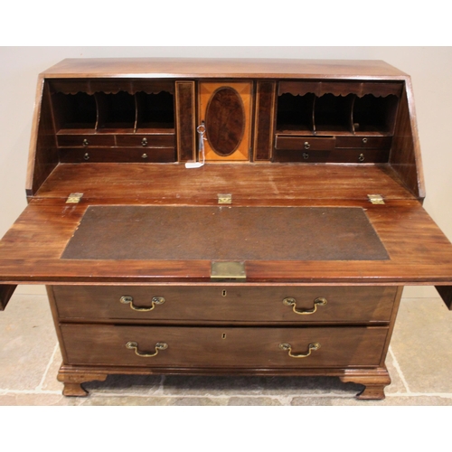 748 - A George III mahogany bureau, the fall front above two short and three long drawers and opening to r... 