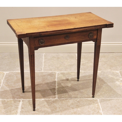 754 - A George III mahogany folding card table, the rectangular hinged top with inlaid stringing and exten... 