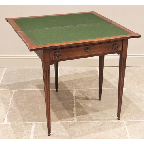 754 - A George III mahogany folding card table, the rectangular hinged top with inlaid stringing and exten... 