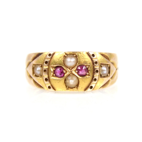 76 - A Victorian ruby and pearl 15ct gold ring, the central floral head set with two half pearls and two ... 