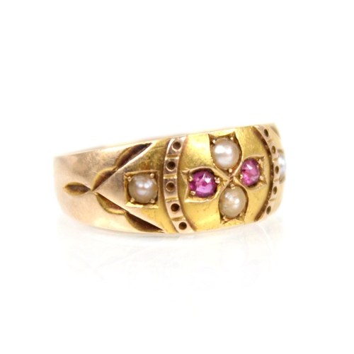 76 - A Victorian ruby and pearl 15ct gold ring, the central floral head set with two half pearls and two ... 