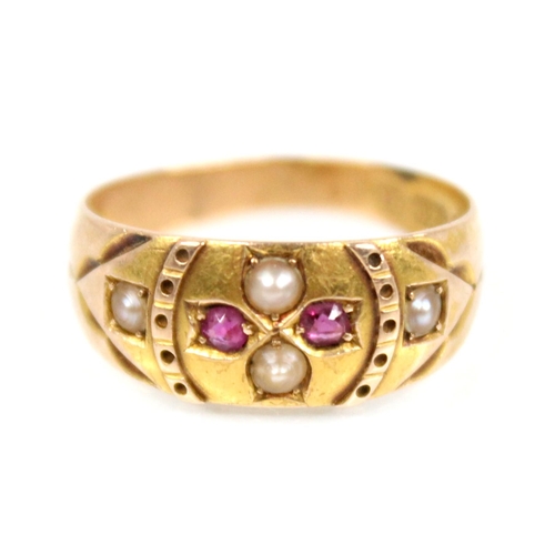 76 - A Victorian ruby and pearl 15ct gold ring, the central floral head set with two half pearls and two ... 