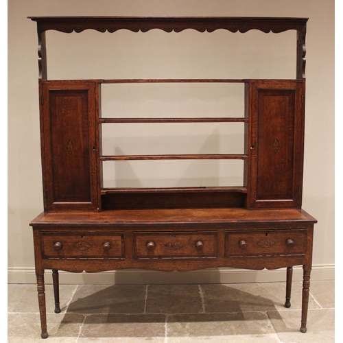 763 - A George III oak and mahogany crossbanded dresser, the open plate rack with a moulded cornice and wa... 