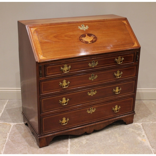 764 - A George III mahogany bureau, the hinged fall front centred with an inlaid boxwood urn confined by s... 