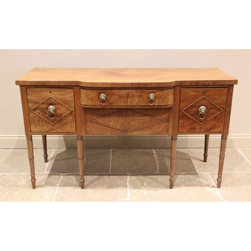 769 - A late George III mahogany breakfront sideboard, the shaped top with a simulated reeded edge above a... 