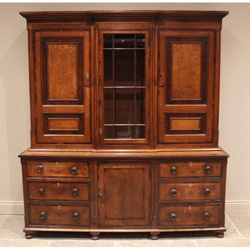 771 - A George III oak, mahogany and rosewood crossbanded housekeepers cupboard, the upper section of brea... 