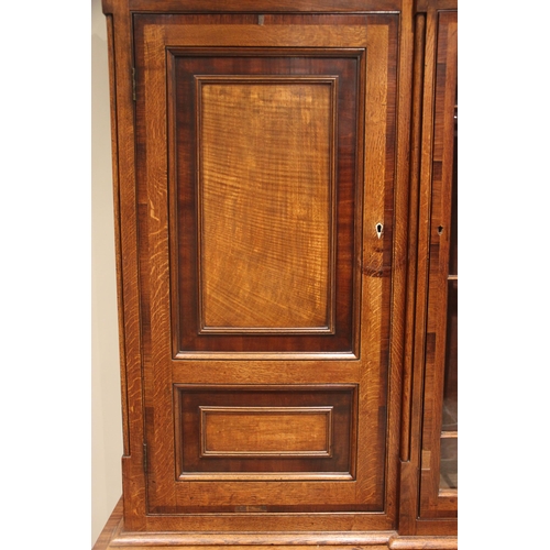 771 - A George III oak, mahogany and rosewood crossbanded housekeepers cupboard, the upper section of brea... 