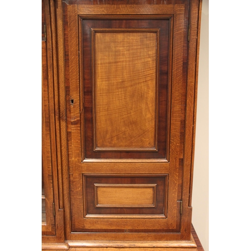 771 - A George III oak, mahogany and rosewood crossbanded housekeepers cupboard, the upper section of brea... 