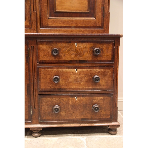 771 - A George III oak, mahogany and rosewood crossbanded housekeepers cupboard, the upper section of brea... 