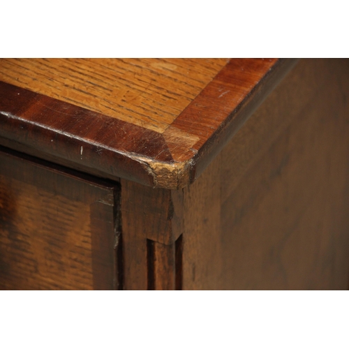 771 - A George III oak, mahogany and rosewood crossbanded housekeepers cupboard, the upper section of brea... 